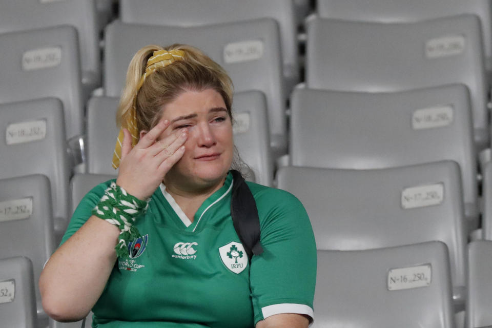 An Ireland fan reacts after the team lost to New Zealand in the Rugby World Cup quarterfinal match at Tokyo Stadium in Tokyo, Japan, Saturday, Oct. 19, 2019. (AP Photo/Eugene Hoshiko)