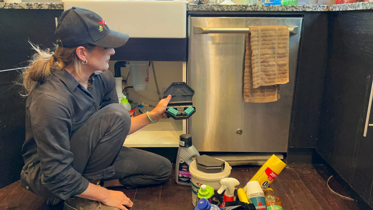 Ava Dickman, a technician with AAA Exterminating Inc., checks a rodent bait station inside a home in Indianapolis. (AP Photo/Casey Smith)