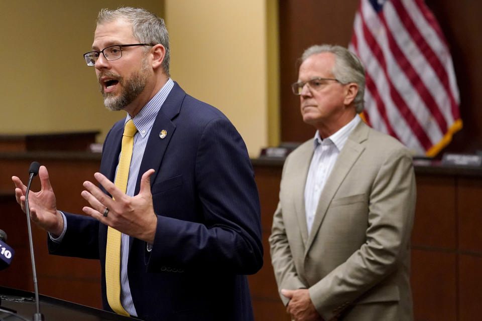 Pinal County Board of Supervisors Chairman Jeffrey McClure, right, listens as Pinal County Attorney Kent Volkmer addresses election day ballot shortages Pinal county, Wednesday, Aug. 3, 2022, in Florence, Ariz. (AP Photo/Matt York)