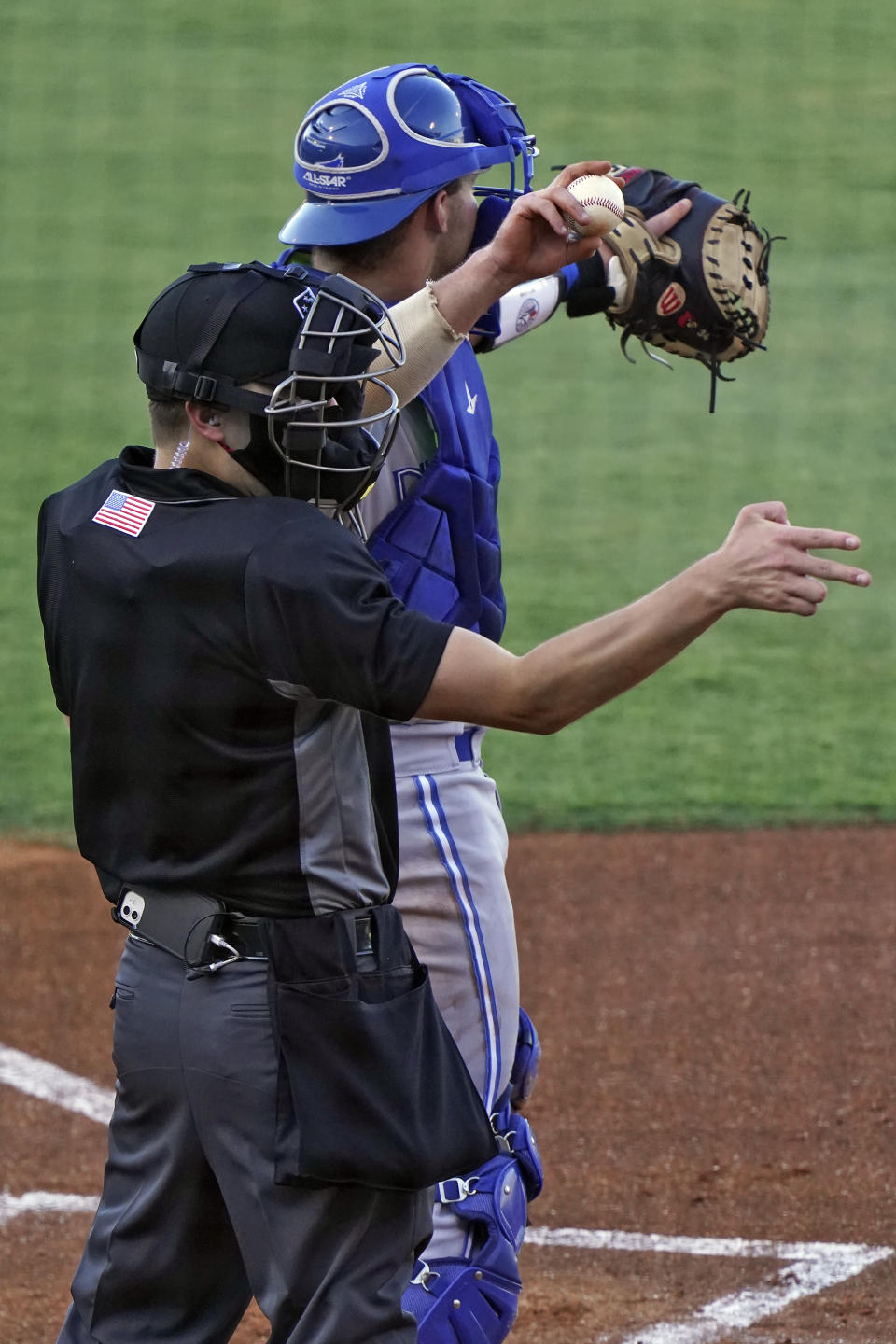 Home plate umpire Kaleb Devier calls a strike during a Low A Southeast League baseball game between the Dunedin Blue Jays and the Tampa Tarpons at George M. Steinbrenner Field Tuesday, May 4, 2021, in Tampa, Fla. The game is one of the first in the league to use automatic balls and strike calls. (AP Photo/Chris O'Meara)