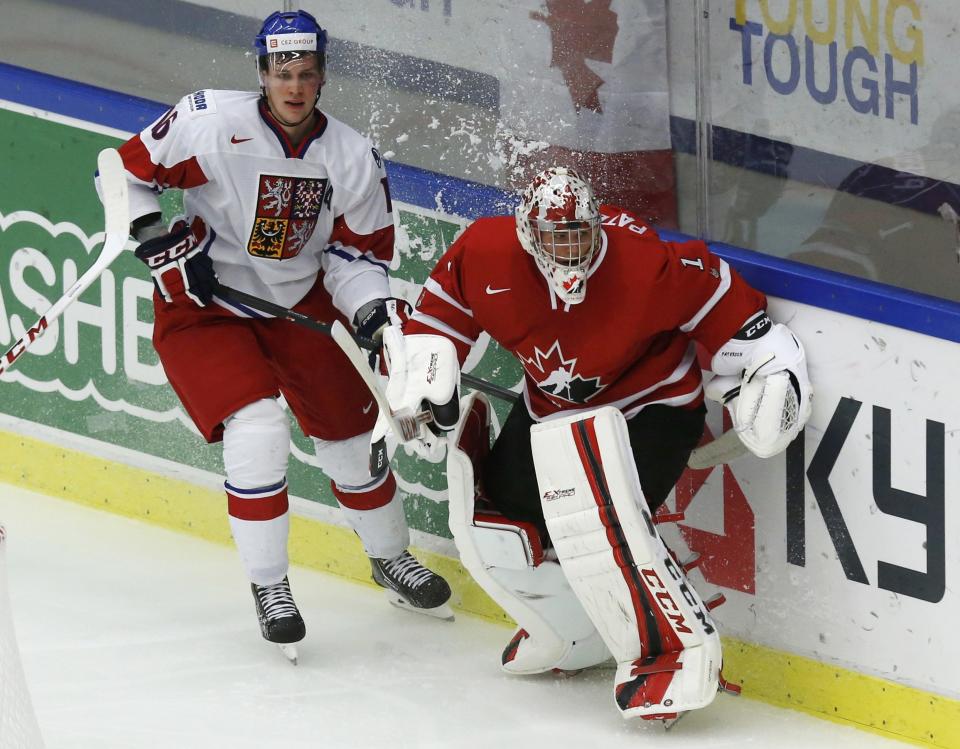 Czech Republic's Faksa and Canada's goalie Paterson bump behind the net while clearing the puck during the second period of their IIHF World Junior Championship ice hockey game in Malmo