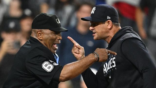 Yankees' Aaron Boone mimes umpire calling strike three during