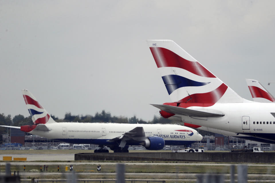 FILE - In this Sept. 9, 2019, file photo, a British Airways plane, left, is towed past other planes sitting parked at Heathrow Airport in London. The outbreak of the new virus threatens to erase $29 billion of this year's revenue for global airlines, mostly for Chinese carriers, as travel crashes worldwide, according to the International Air Transport Association. International airlines including British Airways, Germany’s Lufthansa, Australia’s Qantas and the three largest U.S. airlines have suspended flights to China, in some cases until late April or May. (AP Photo/Matt Dunham, File)