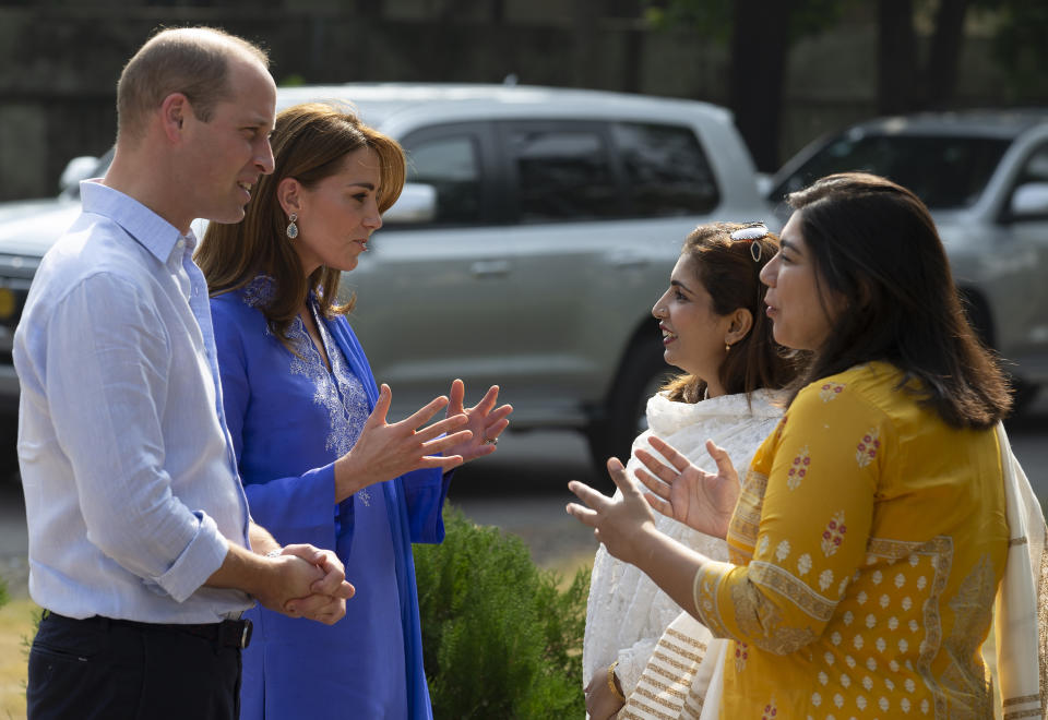 Britain's Prince William and his wife Kate speaks to teachers during their visit to a school in Islamabad, Pakistan, Tuesday, Oct. 15, 2019. The Duke and Duchess of Cambridge, who are strong advocates of girls' education were greeted by teachers and children. (AP Photo/B.K. Bangash)