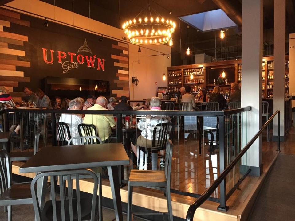 The interior of Uptown Grill, a new restaurant and bar that has taken over the space previously occupied by Tipsy Piano Bar. The space has been brightened with a chandelier.