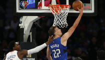 Orlando Magic's Franz Wagner (22) scores a basket while defended by New York Knicks' RJ Barrett during an NBA basketball game Sunday, Oct. 24, 2021, in New York. (AP Photo/John Munson)