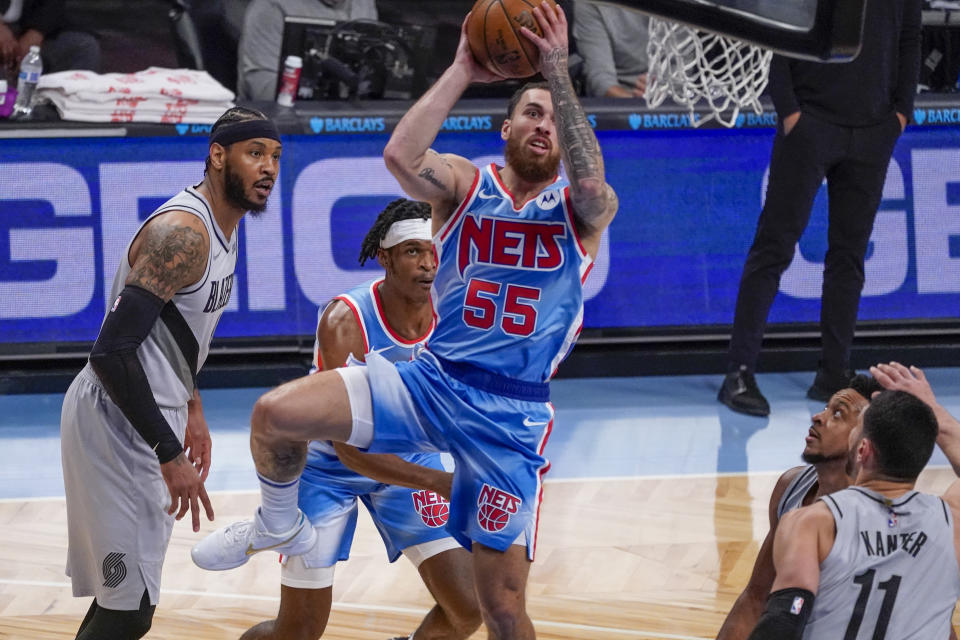 Brooklyn Nets guard Mike James (55) goes to the basket past Portland Trail Blazers forward Carmelo Anthony, left, and center Enes Kanter (11) during the first half of an NBA basketball game, Friday, April 30, 2021, in New York. (AP Photo/Mary Altaffer)
