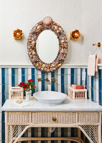 PHOTOGRAPHY BY LAUREY W. GLENN; STYLING BY KENDRA SURFACE Your guests will likely visit the restroom, so invest in the details, says Charlotte. She updated the retrofitted vintage wicker vanity with a coat of paint.