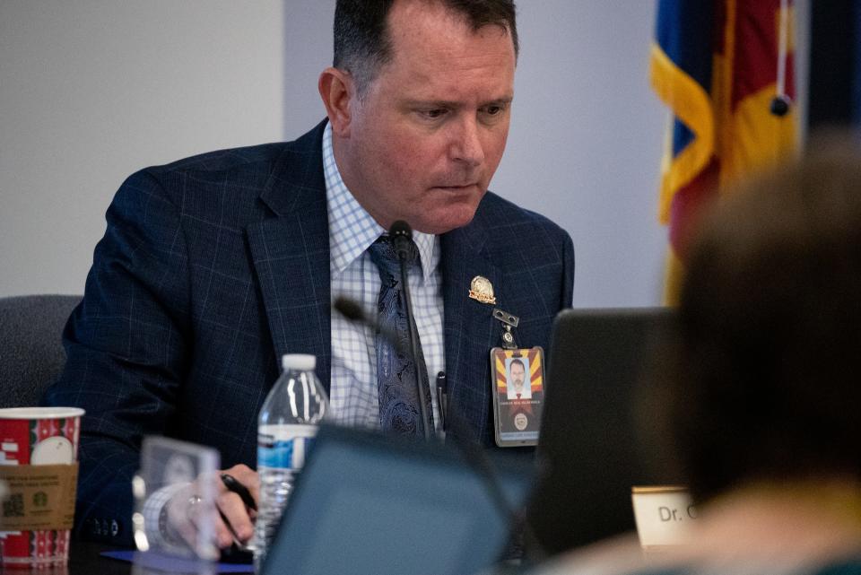 Dr. Charles Seal-Villafranca, vice president of the Arizona Board of Nursing Care Institution Administrators and Assisted Living Facility Managers (AZNCIA) checks his computer during an AZNCIA meeting, Nov. 15, 2021, in the board office in Phoenix, Arizona.