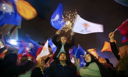 People wave flags outside the AK Party headquarters in Istanbul, Turkey November 1, 2015. REUTERS/Osman Orsal