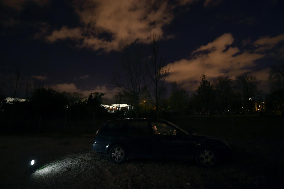 Juan Jimenez, 60, sits in his car which is now his home, in Pamplona, northern Spain, Tuesday, March 17, 2021. Jimenez moves his car from one quiet parking spot to another on the outskirts of the northern Spanish city of Pamplona, where he once had a home. (AP Photo/Alvaro Barrientos)