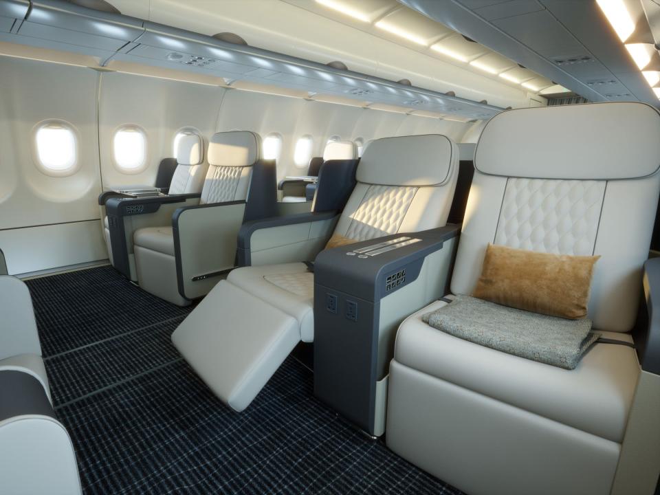 Beige seats with a yellow felt pillow onboard TCS' A321neo in a 2x2 layout.