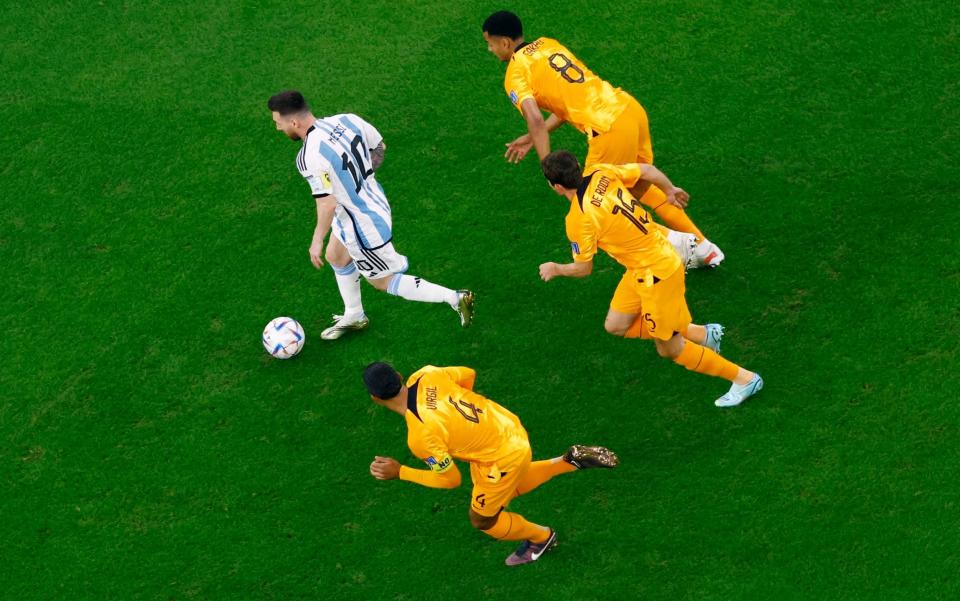 Argentina's Lionel Messi in action with Netherlands' Virgil van Dijk, Marten de Roon and Cody Gakpo - REUTERS/Peter Cziborra