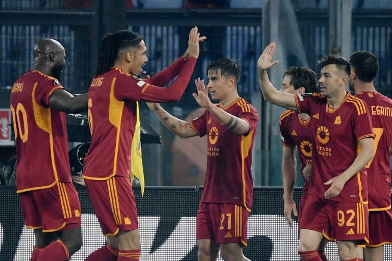 Paulo Dybala (en el centro, número 21) festeja con sus compañeros su gol en la victoria de la Roma sobre el Milan que clasificó a su equipo para semifinales de la Europa League. En Roma, el 18 de abril de 2024 (Filippo MONTEFORTE)