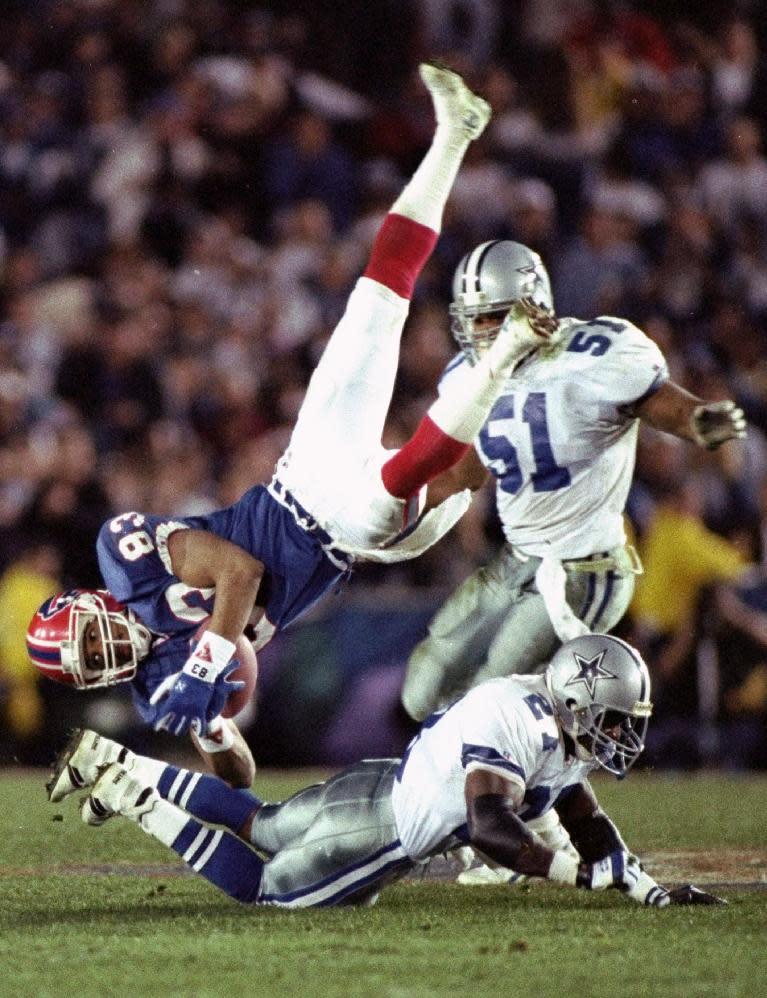 FILE - In this Jan. 31, 1993 file photo, Buffalo Bills' wide receiver Andre Reed is upended by Dallas Cowboys' strong safety Thomas Everett after a 13-yard reception in the third quarter of the Super Bowl in Pasadena, Calif. Reed was elected to the Pro Football Hall of Fame on Saturday, Feb. 1, 2014. (AP Photo/Doug Mills, File)