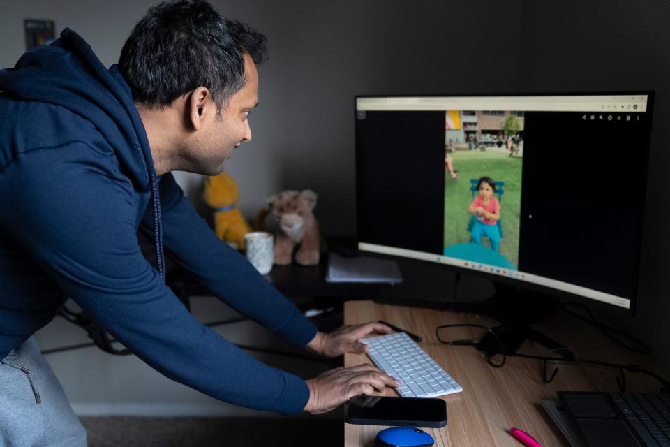Shantau Prakash, a tech worker in Columbus on an H-1B visa, shows photos of his son, who lives in India with his family. He is able to communicate with his son every day.