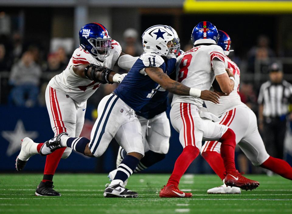Dallas Cowboys linebacker Micah Parsons (11) sacks New York Giants quarterback Daniel Jones (8) as offensive tackle Andrew Thomas (78) attempts to block during the game between the Dallas Cowboys and the New York Giants at AT&T Stadium.