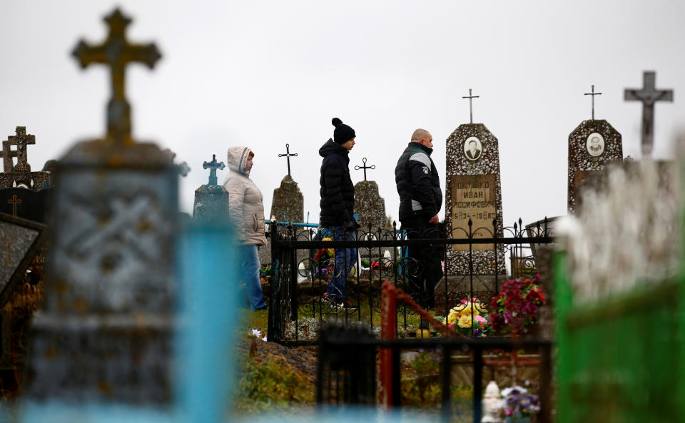 <p>People visit graves of their relatives during All Saints’ Day at a cemetery in the village of Baruny, Belarus, Nov. 1, 2017. (Photo: Vasily Fedosenko/Reuters) </p>