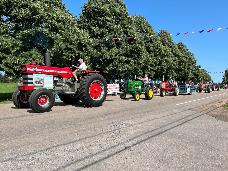 An antique tractor parade Saturday in Abrams Village, P.E.I. payed tribute to the life of late dairy farmer Jean-Guy Arsenault. 