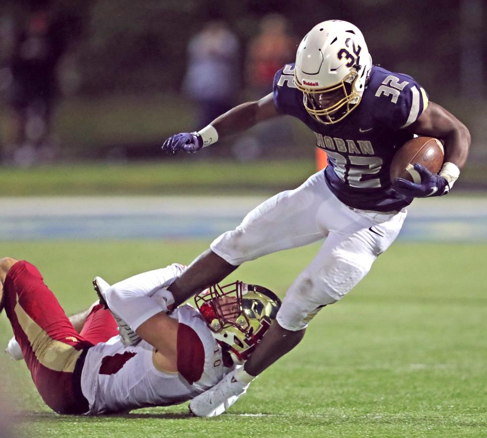 Bergen Catholic's John Fiore takes down Hoban running back Lamar Sperling during a third quarter run on Friday, August 27, 2021 in Akron, Ohio, at Dowd Field.  [Phil Masturzo/ Beacon Journal]