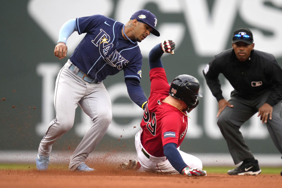 Tampa Bay Rays shortstop Wander Franco, left, tags out Boston Red Sox's Alex Verdugo, center, on a steal-attempt during the eighth inning of a baseball game at Fenway Park, Monday, June 5, 2023, in Boston. (AP Photo/Charles Krupa)