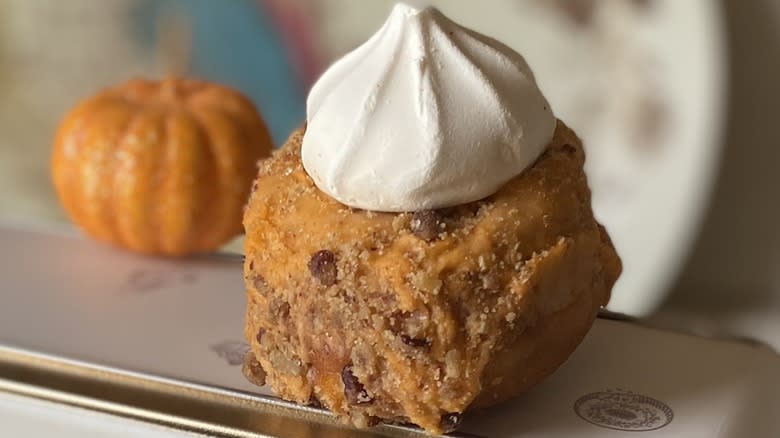 Pumpkin doughnut on tin with fake pumpkin