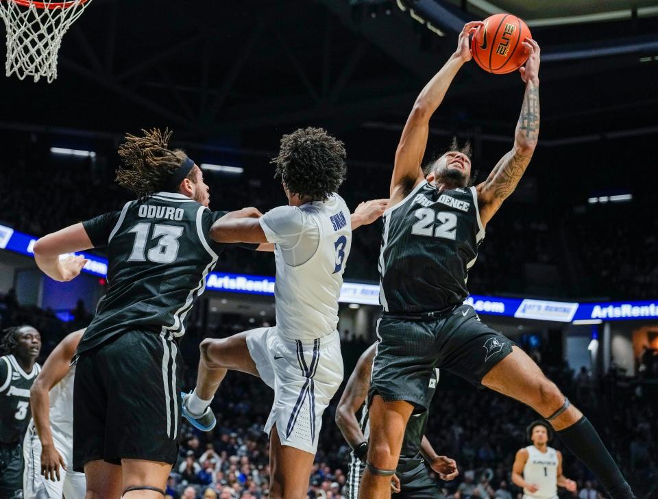 Providence Friars guard Devin Carter (22) grabs a rebound over Xavier Musketeers guard Dailyn Swain (3) in the first half Wednesday, February 21, 2024 at the Cintas Center. Xavier won 79-75.