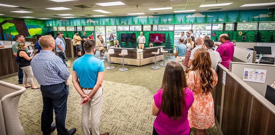 Employees of Booz Allen Hamilton's Agile Center of Excellence in Melbourne gather to hear remarks from Chief Executive Officer Horacio Rozanski.