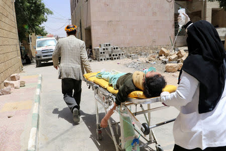 A school girl is being rushed on a stretcher to a hospital after she was injured by an airstrike near her school in Saada, Yemen April 9, 2018. REUTERS/Naif Rahma