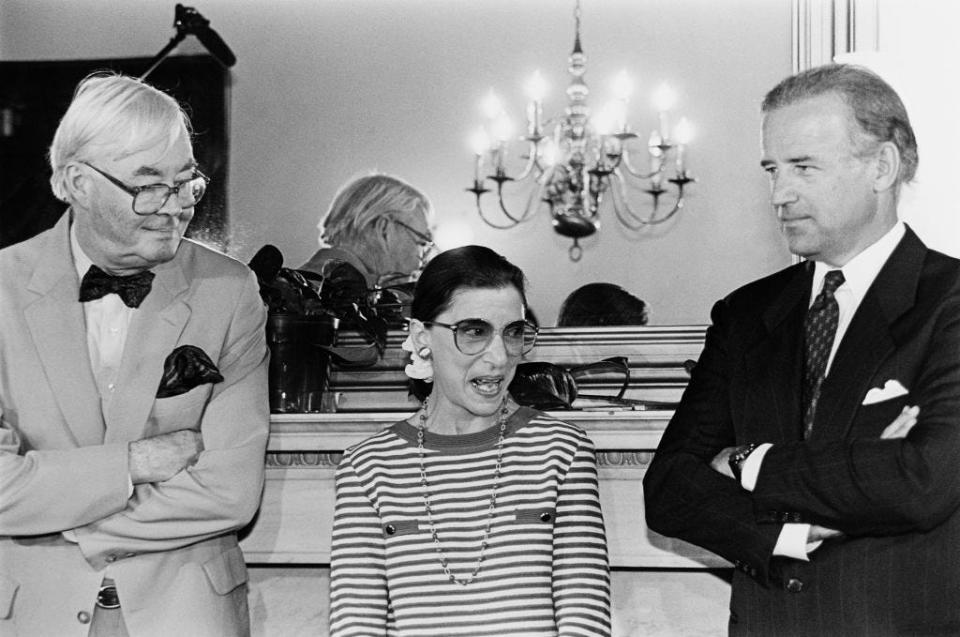 Supreme Court nominee Ruth Bader Ginsburg answering reporter's questions during courtesy call to Senator Joe Biden's office. She's standing with Sens. Biden and Daniel Patrick Moynihan, D-N.Y. June 15, 1993