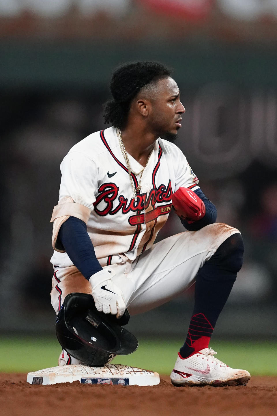 Atlanta Braves' Ozzie Albies (1) kneels at second base after being caught stealing in the fifth inning of a baseball game against the Colorado Rockies Tuesday, Sept. 14, 2021, in Atlanta. (AP Photo/John Bazemore)