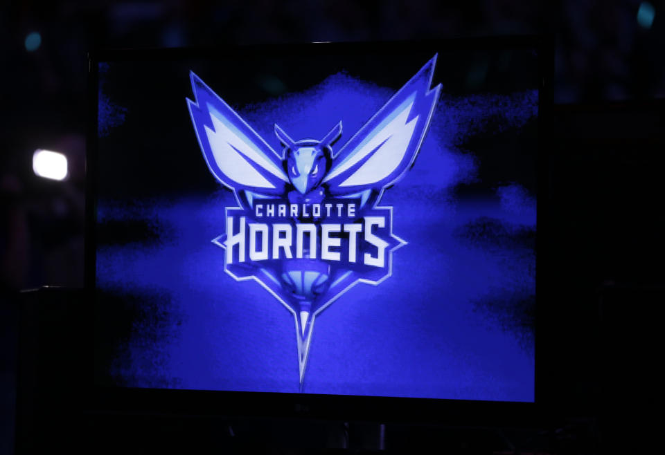 The Charlotte Hornets' new logo is displayed on a video monitor during a halftime ceremony at an NBA basketball game between the Charlotte Bobcats and the Utah Jazz in Charlotte, North Carolina, Saturday, Dec. 21, 2013. The Bobcats will change their name to the Hornets next season.  (AP Photo/Chuck Burton)