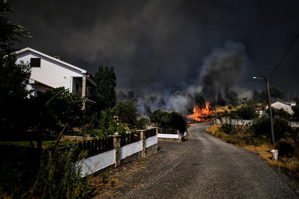 A wildfire approaches a house at Casas da Ribeira village in Macao, central Portugal on July 21, 2019. (Photo: Patricia De Melo Moreira/AFP/Getty Images)