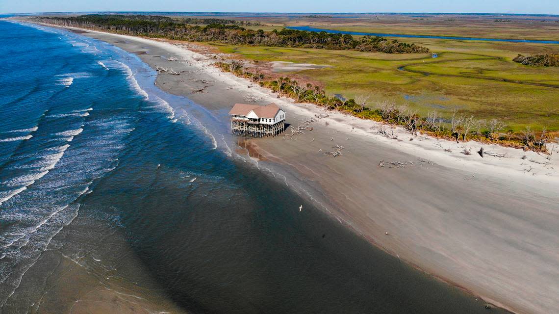 A photo taken with a drone shows the tide coming in Friday, April 8, 2022, to Pritchards Island where the abandoned USC-owned laboratory formerly that was used for coastal research and the study of loggerhead turtles is being consumed by erosion. Its pilings were once hidden by beach that extended about 300 yards in front of the structure.