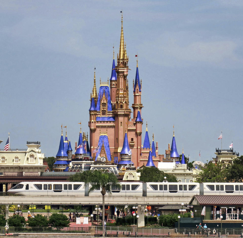 A view of Cinderella Castle from Seven Seas Lagoon in the Magic Kingdom at Walt Disney World, in Lake Buena Vista, Fla., Wednesday, Sept. 30, 2020. The Walt Disney Co. announced Tuesday that it is planning to lay off 28,000 workers in its theme parks division in California and Florida. The company has been squeezed by limits on attendance at its parks and other restrictions due to the pandemic. (Joe Burbank/Orlando Sentinel via AP)