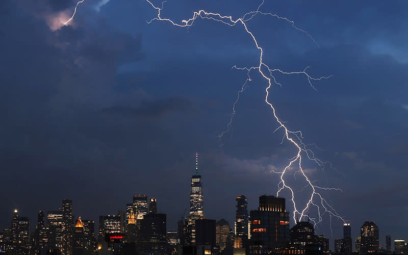 A bolt of lightning strikes behind One World Trade Center