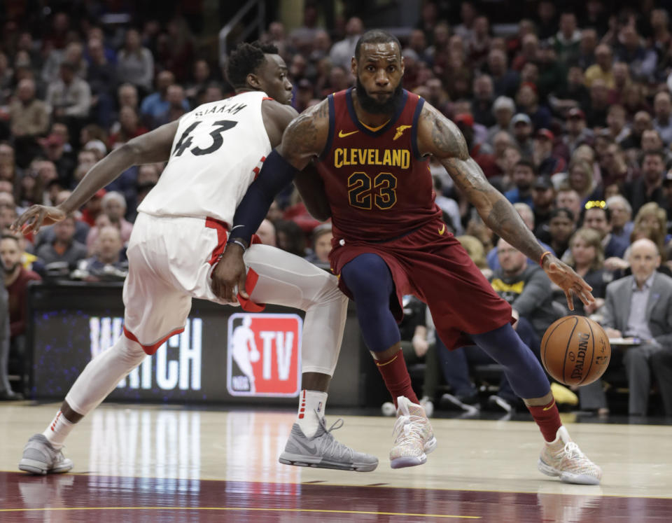 LeBron James spins past Raptors forward Pascal Siakam on his way to the basket. (AP)