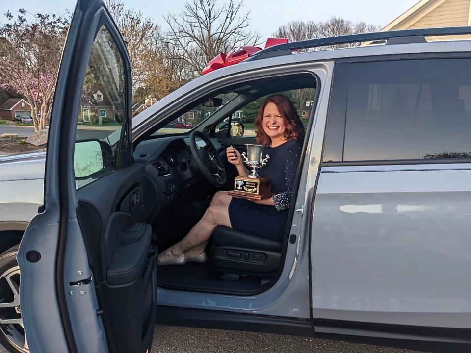 Elizabeth McDonald, biomedical science teacher at Washington County Technical High School, sitting in her new Honda Passport. She received the car as a gift for being named Washington County Public Schools' Teacher of the Year Wednesday night.