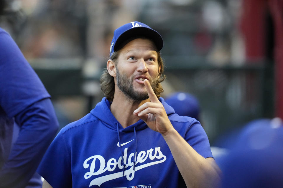 Los Angeles Dodgers pitcher Clayton Kershaw gestures in the dugout before Game 3 of a baseball NL Division Series against the Arizona Diamondbacks, Wednesday, Oct. 11, 2023, in Phoenix. (AP Photo/Ross D. Franklin)