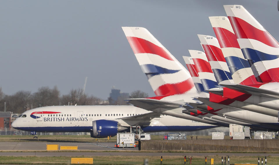 A view of British Airways planes parked at London's Heathrow Airport, Wednesday,  Jan. 29, 2020. British Airways and Asian budget carriers Lion Air and Seoul Air have joined a growing list of airlines that are suspending flights to China as fears spread about the outbreak of a new virus that has killed more than 130 people. (Steve Parsons/PA via AP)