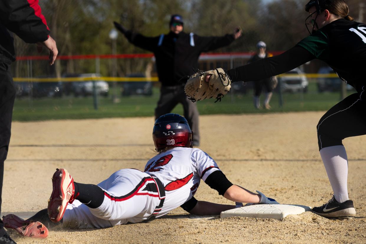 Stillman Valley runner Abby Gillium (12) looks to the umpire for his call after sliding into third base during a game against North Boone on Friday, April 19, 2024, at the Davis Junction Softball Fields in Davis Junction.