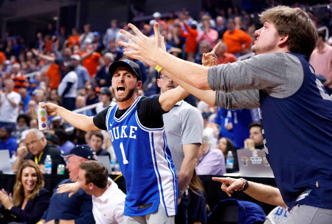 A Duke fan and Virginia fan have different reactions to the official’s call during the second half of Duke’s 59-49 victory over Virginia to win the ACC Men’s Basketball Tournament in Greensboro, N.C., Saturday, March 11, 2023.