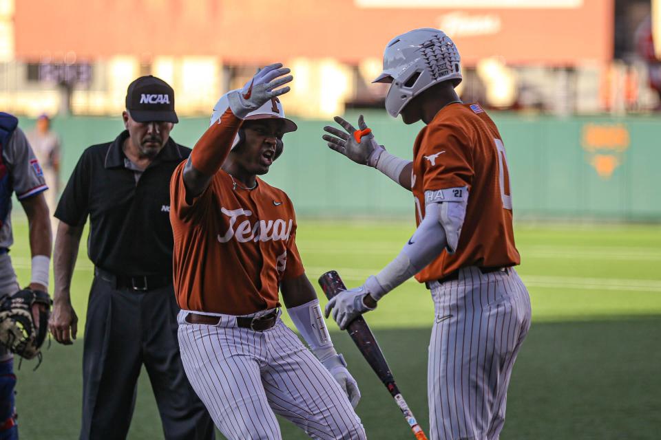 Texas' Dylan Campbell, left, and Trey Faltine celebrate a run in the win over Louisiana Tech in the Austin Regional on June 4. The Longhorns enter this week's College World Series as the field's top team in batting average, home runs and runs per game.