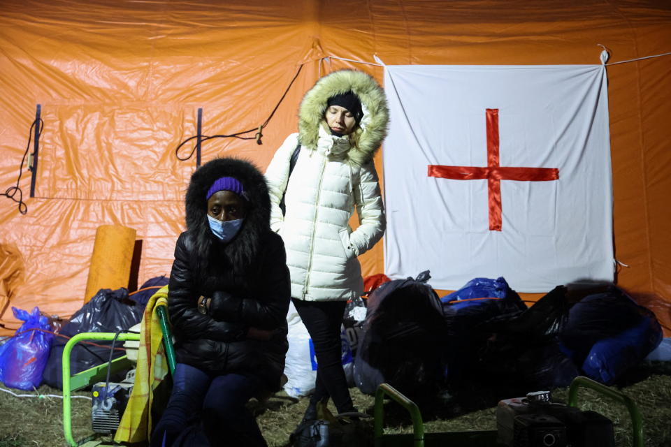 Refugees wait for help in a parking lot as transportation and accommodation are being organised  for them to reach different cities in Poland and other countries as well after Russia launched a massive military operation against Ukraine, in Przemysl, Poland February 26, 2022. REUTERS/Kacper Pempel