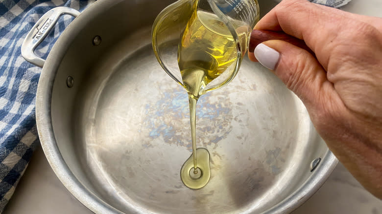 adding oil to a pan