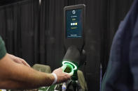 An exhibitor demonstrates the OneThird avocado ripeness checker during CES Unveiled before the start of the CES tech show, Tuesday, Jan. 3, 2023, in Las Vegas. The device is designed for use by grocery store shoppers to scan an avocado and get information about when it is ready to eat. (AP Photo/John Locher)