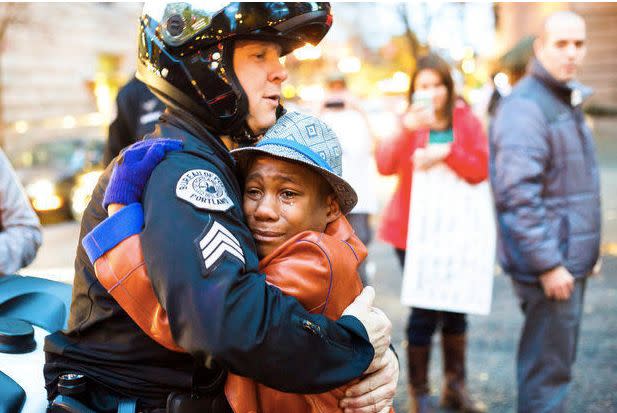 The viral moment when Devonte Hart and a police officer hugged at a demonstration. (Photo: Johnny Nguyen)