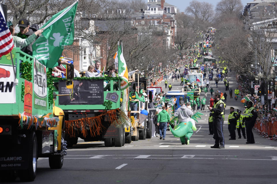 Floats and vehicles make their way along the parade route as spectators watch during the St. Patrick's Day parade, Sunday, March 17, 2024, in Boston's South Boston neighborhood. (AP Photo/Steven Senne)