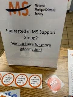 Dan Roca sets up a sign to provide information about the MS Support Group in the county.