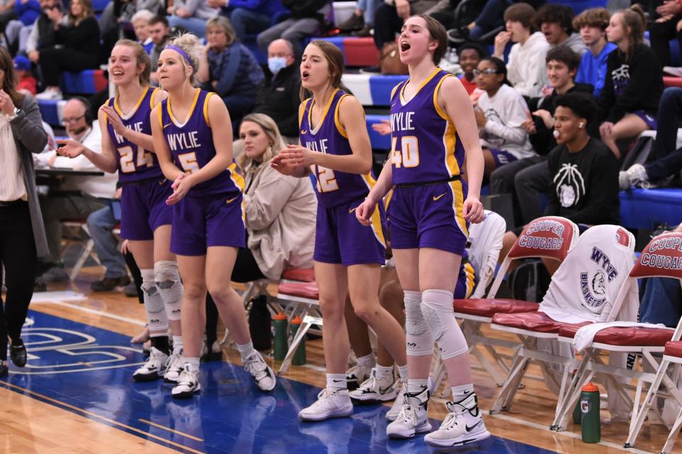 The Wylie bench reacts to Kenyah Maroney's go-ahead basket during the third quarter of Friday's Southtown game against Cooper.